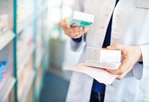 Pharmacist's hands taking medicines from shelf